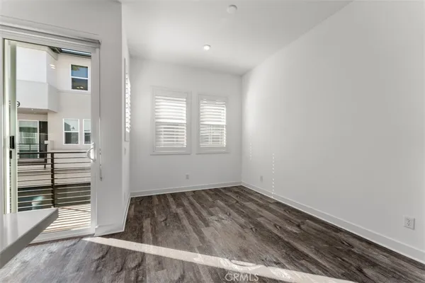 a large white kitchen with kitchen island a sink stainless steel appliances and cabinets