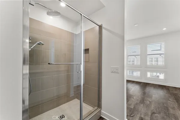a spacious bathroom with a shower and a sink