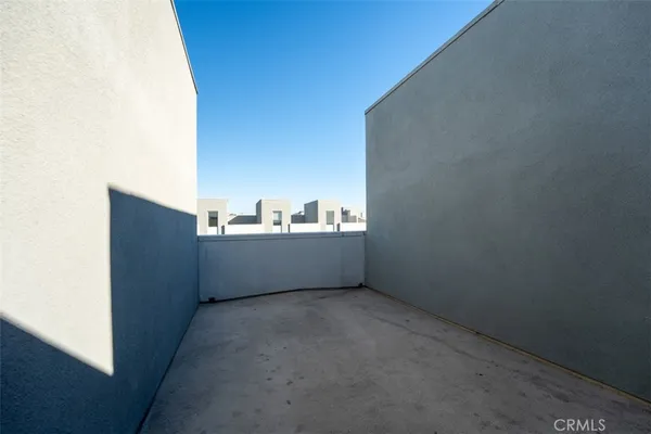 a view of a building with sitting area and garden