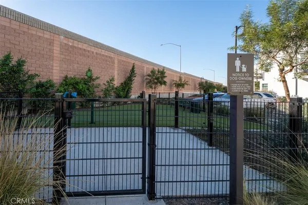 a view of a patio with couches table and chairs and potted plants