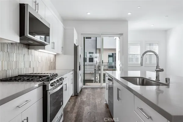 a kitchen with refrigerator and cabinets