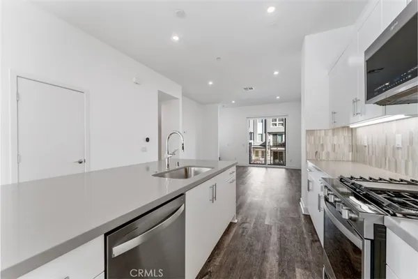 a kitchen with stainless steel appliances granite countertop a sink and stove