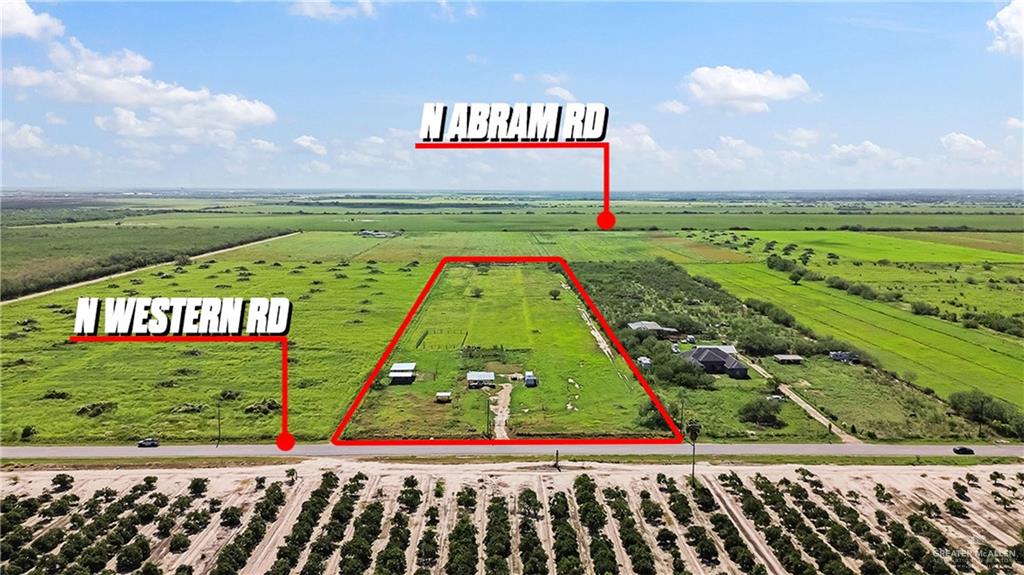Expansive land parcel featuring clear boundaries and direct frontage on a paved road