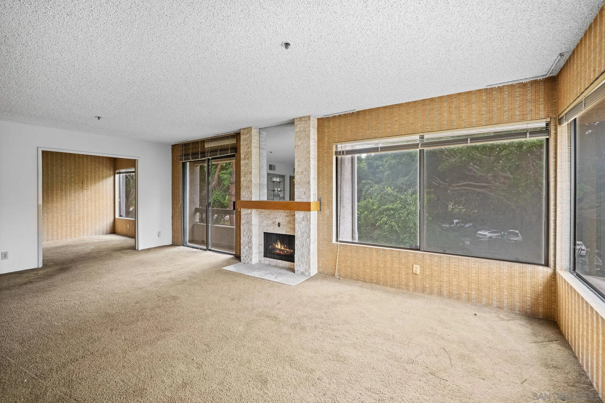 5665 Friars Road, Unit 232 San Diego, CA 92110 - Photo 11 of 30 a view of an empty room with a fireplace and a window