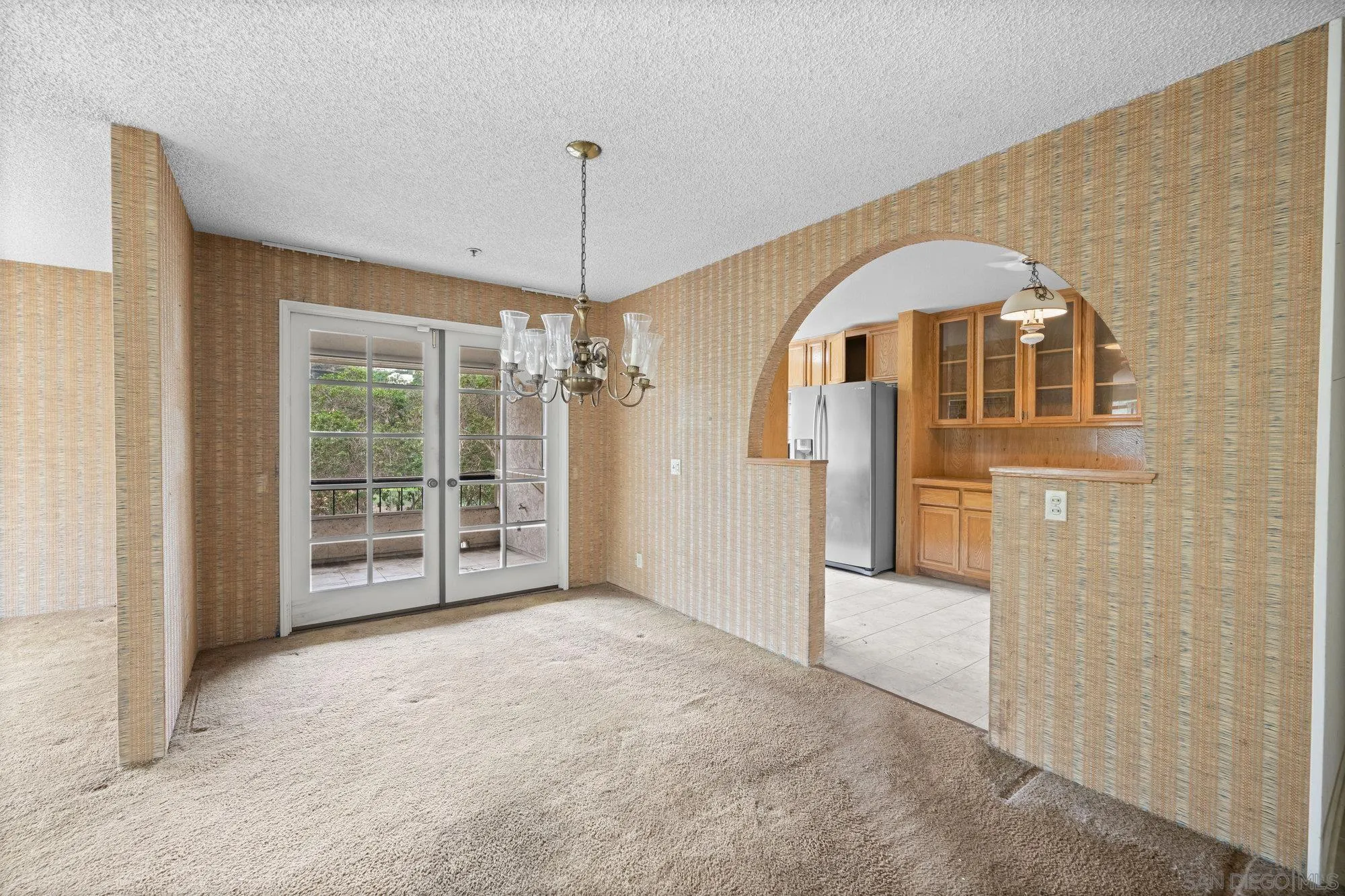5665 Friars Road, Unit 232 San Diego, CA 92110 - Photo 12 of 30 a view of a hallway with a chandelier