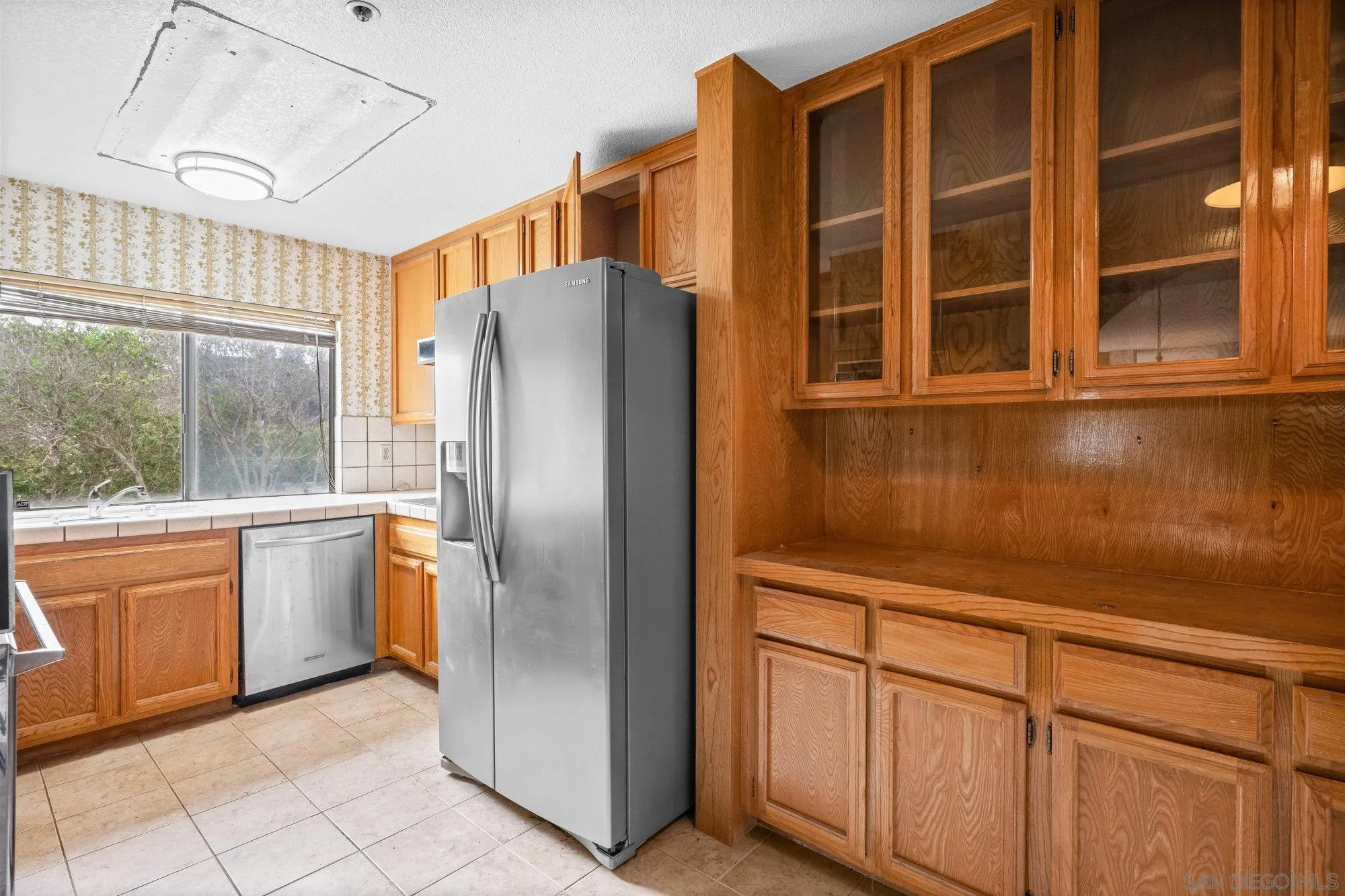 5665 Friars Road, Unit 232 San Diego, CA 92110 - Photo 15 of 30 a kitchen with stainless steel appliances granite countertop a refrigerator and a sink