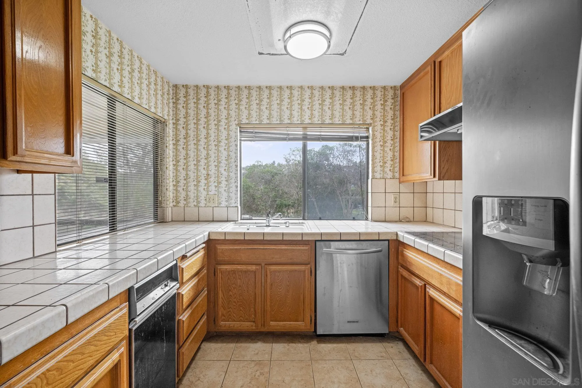 5665 Friars Road, Unit 232 San Diego, CA 92110 - Photo 19 of 30 a kitchen with a sink stove and refrigerator