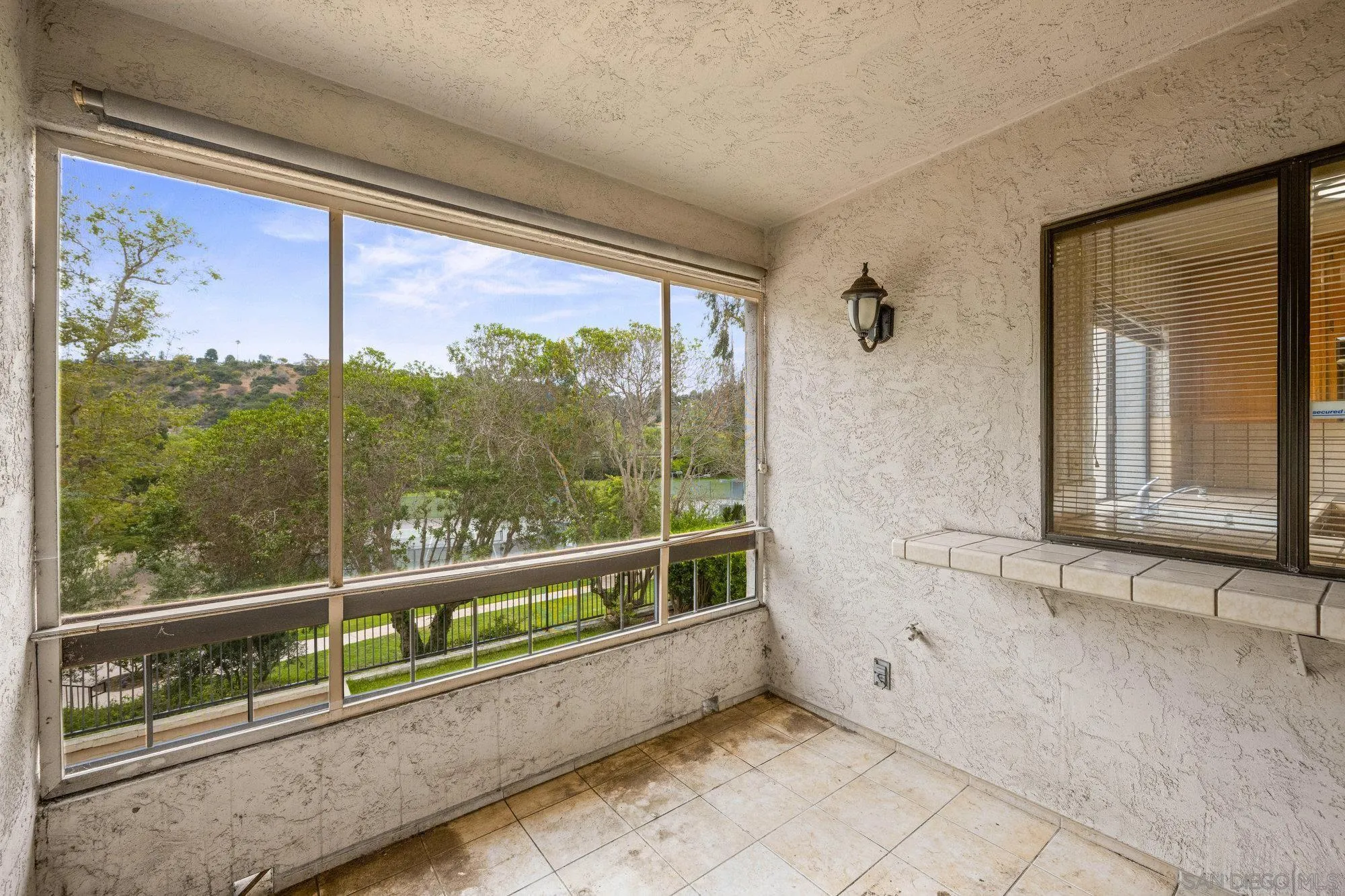 5665 Friars Road, Unit 232 San Diego, CA 92110 - Photo 20 of 30 a view of a porch with a floor to ceiling window
