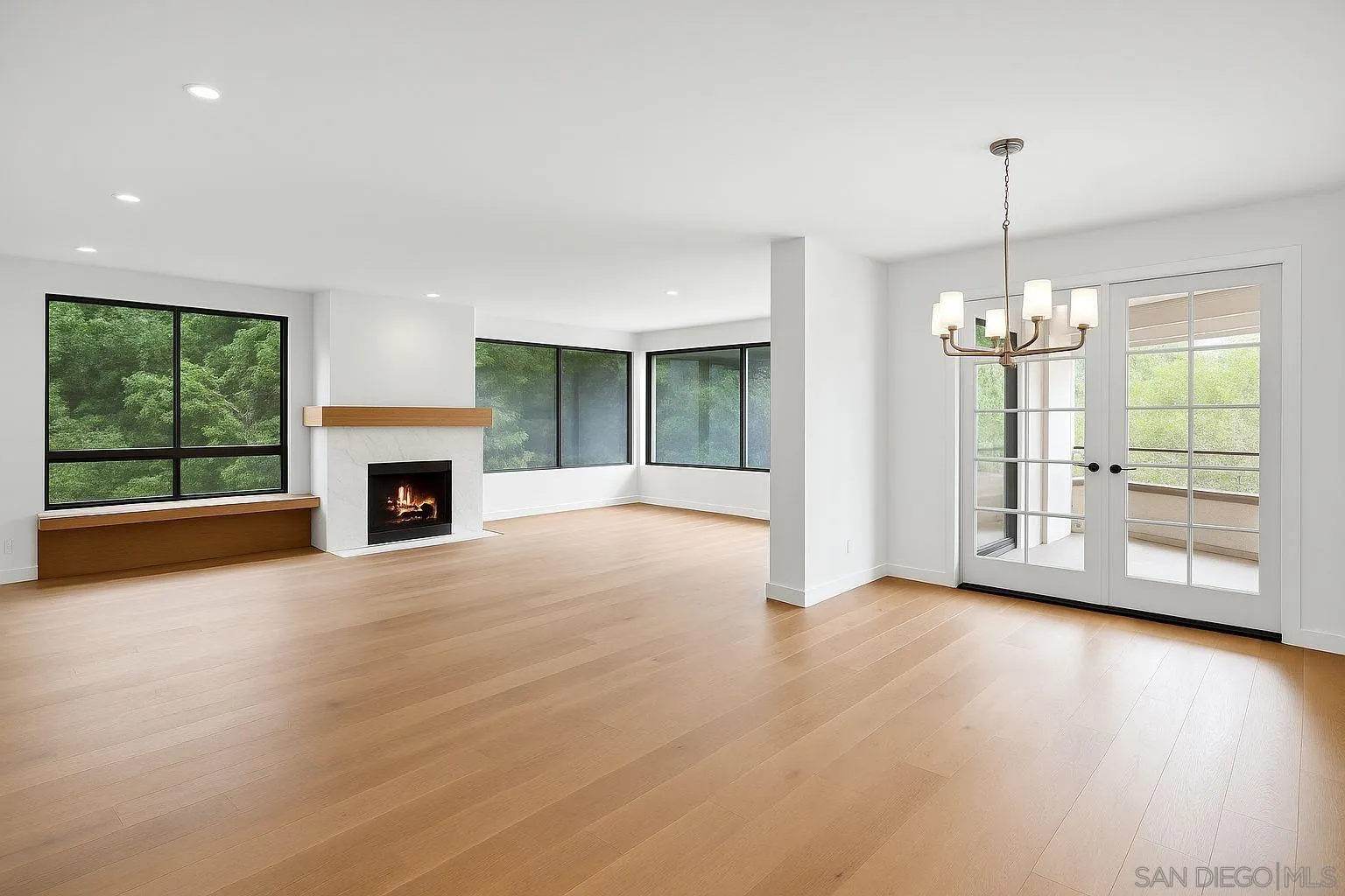 5665 Friars Road, Unit 232 San Diego, CA 92110 - Photo 2 of 30 a view of an empty room with glass door and wooden floor