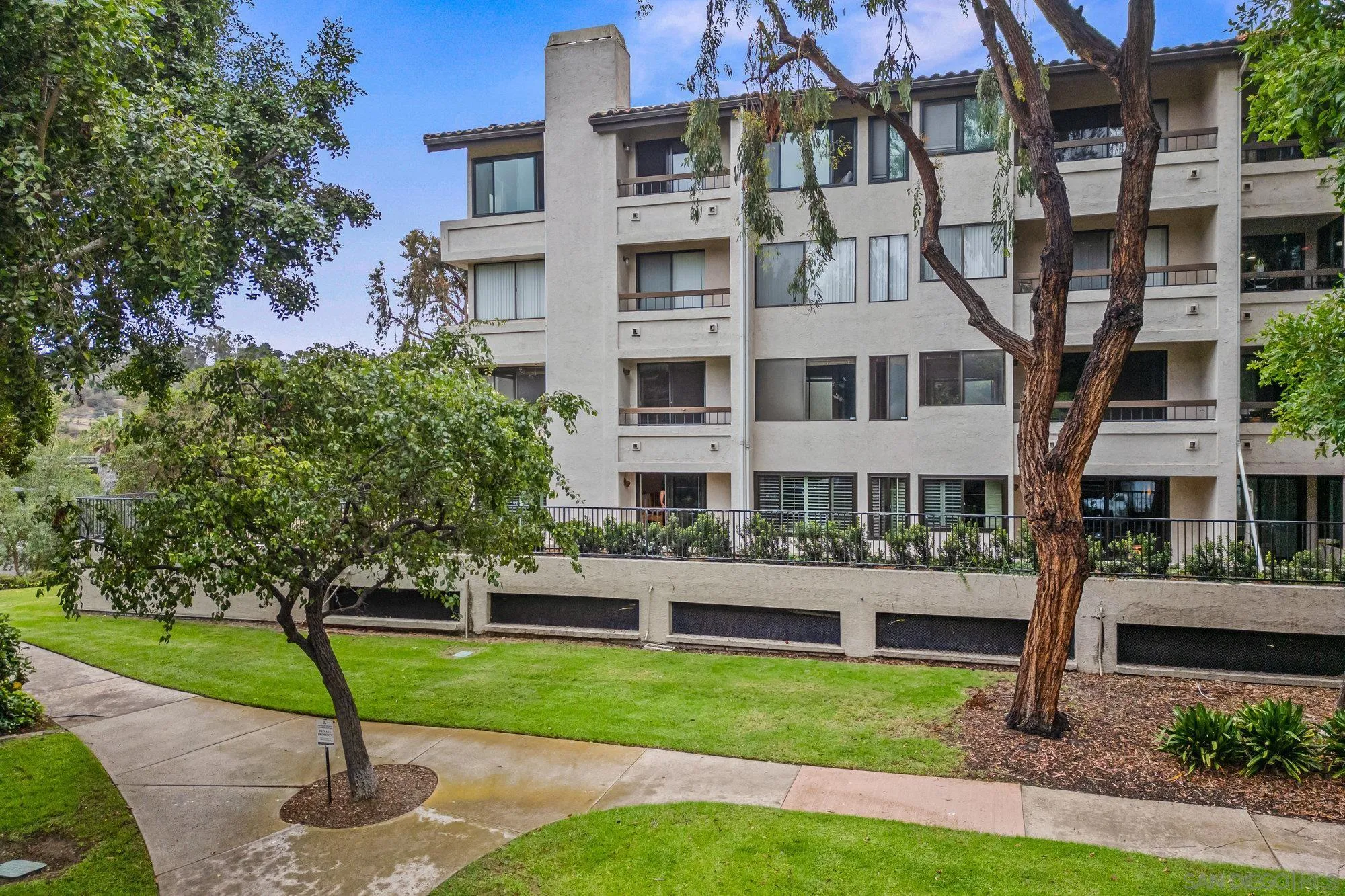 5665 Friars Road, Unit 232 San Diego, CA 92110 - Photo 3 of 30 a front view of a building with garden