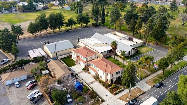 an aerial view of a house with a garden and lake view