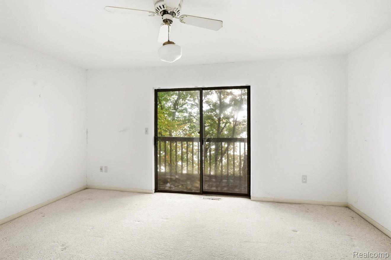 8890 Tipsico Lake Road Holly, MI 48442 - Photo 12 of 20 Sliding glass door leading to an exterior balcony