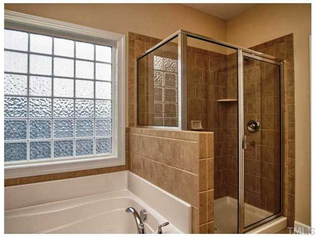 2736 Royal Forrest Drive Raleigh, NC 27614 - Photo 9 of 22 The owner's bath has wonderful tile accents and a deep soaking tub. What a perfect retreat! Master Bath/Spa