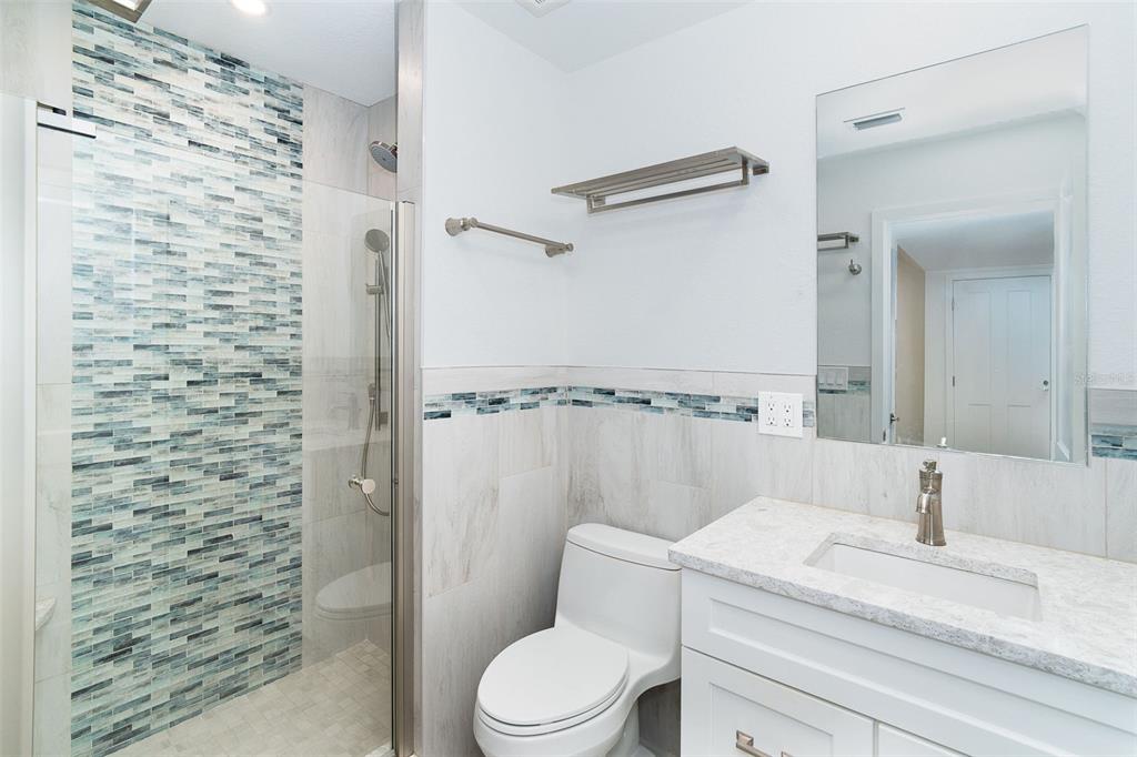 2700 North Beach Road, Unit A201 Englewood, FL 34223 - Photo 13 of 55 a bathroom with a sink a toilet and shower