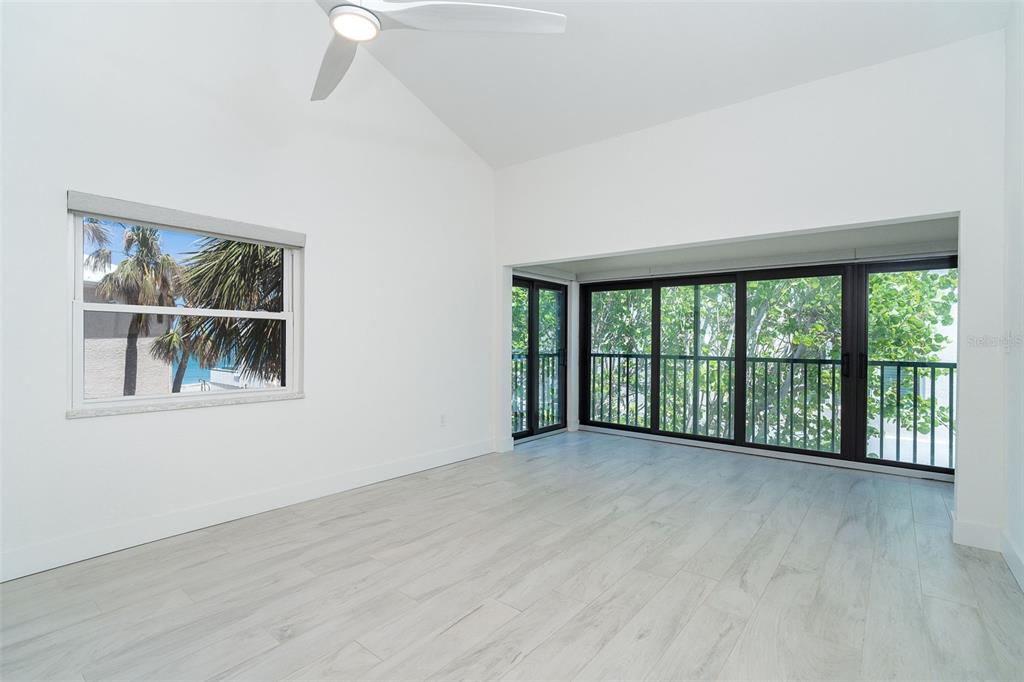 2700 North Beach Road, Unit A201 Englewood, FL 34223 - Photo 19 of 55 a view of an empty room with a window and wooden floor
