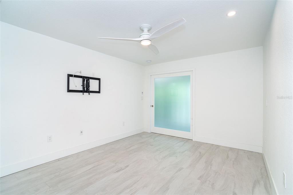 2700 North Beach Road, Unit A201 Englewood, FL 34223 - Photo 28 of 55 an empty room with a ceiling fan and window
