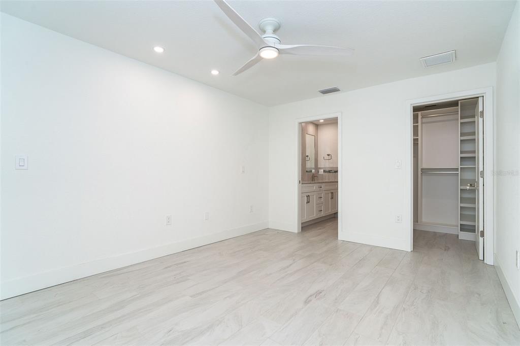 2700 North Beach Road, Unit A201 Englewood, FL 34223 - Photo 29 of 55 an empty room with closet and a ceiling fan