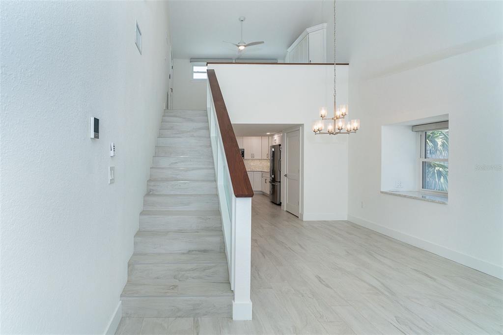 2700 North Beach Road, Unit A201 Englewood, FL 34223 - Photo 34 of 55 a view of a hallway with wooden floor and staircase