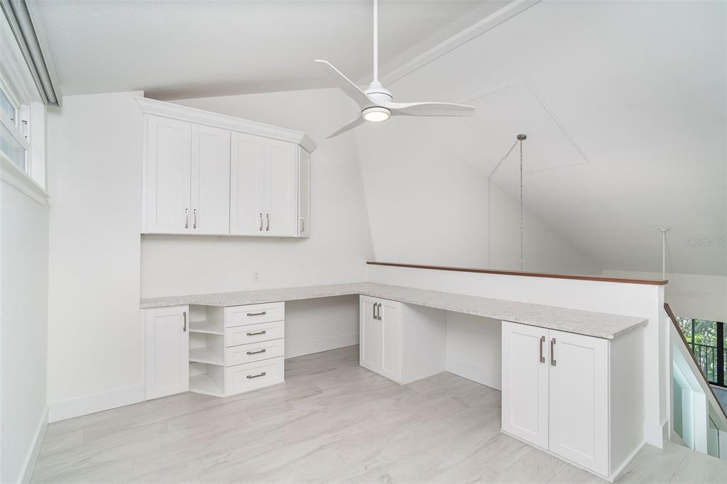 2700 North Beach Road, Unit A201 Englewood, FL 34223 - Photo 37 of 55 a kitchen with white cabinets and a white wall