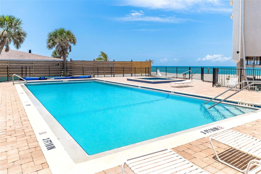 2700 North Beach Road, Unit A201 Englewood, FL 34223 - Photo 47 of 55 a view of a swimming pool with a lounge chairs
