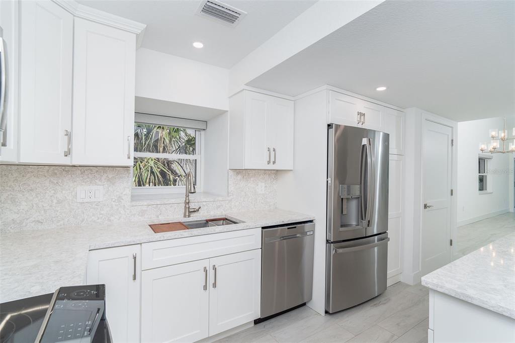 2700 North Beach Road, Unit A201 Englewood, FL 34223 - Photo 7 of 55 a kitchen with appliances a sink and a window
