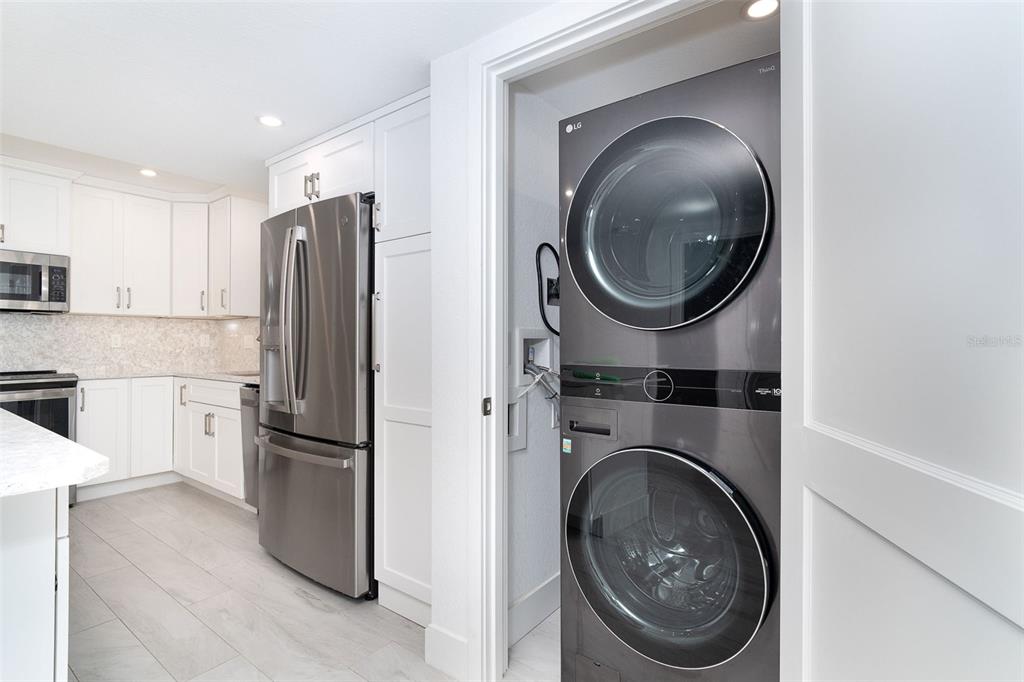 2700 North Beach Road, Unit A201 Englewood, FL 34223 - Photo 8 of 55 a kitchen with a washer and dryer