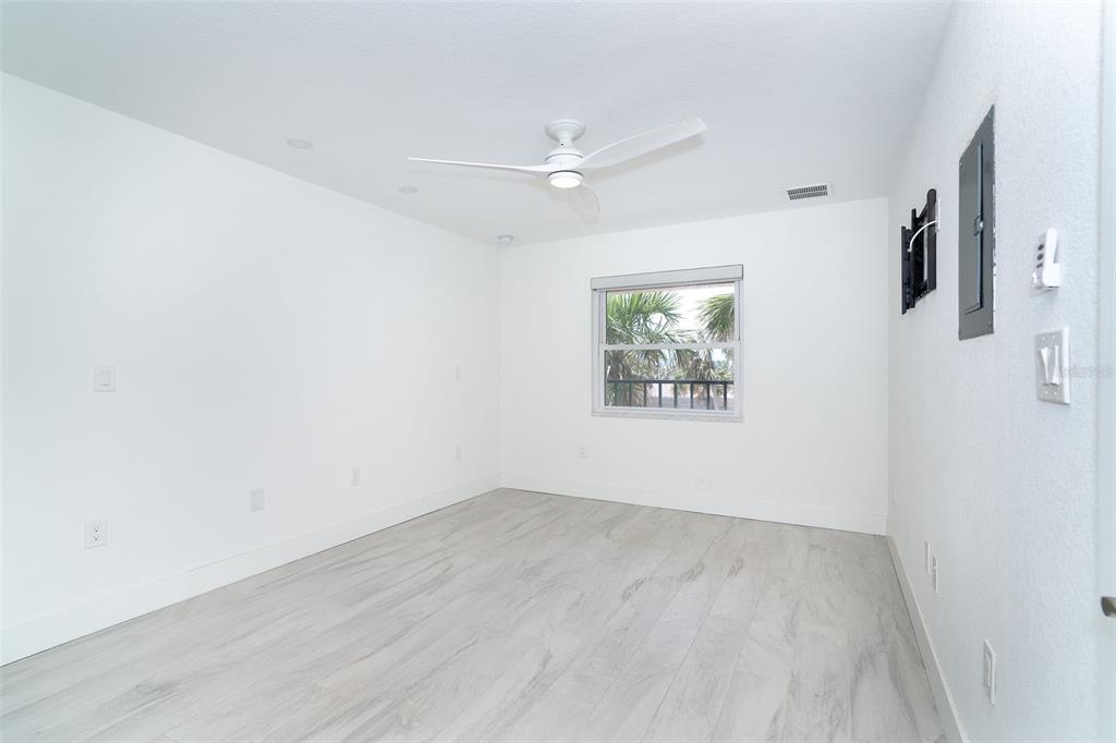 2700 North Beach Road, Unit A201 Englewood, FL 34223 - Photo 10 of 55 an empty room with a ceiling fan and window