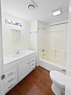 a bathroom with a double vanity sink toilet mirror and bathtub