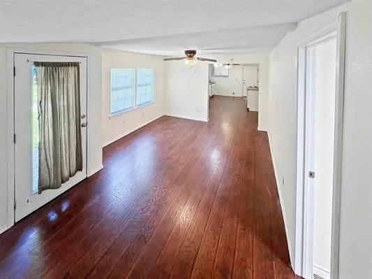 wooden floor in an empty room with a window