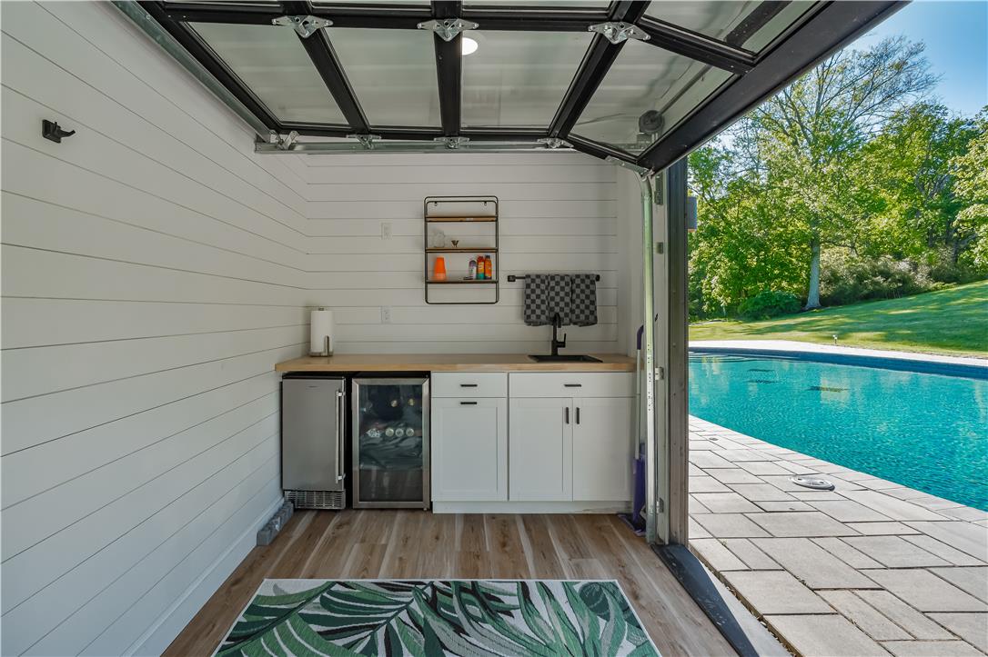 1506 Pleasant View Road Coopersburg, PA 18036 - Photo 88 of 97 An inviting poolside retreat with a convenient outdoor kitchen and vibrant turquoise pool.