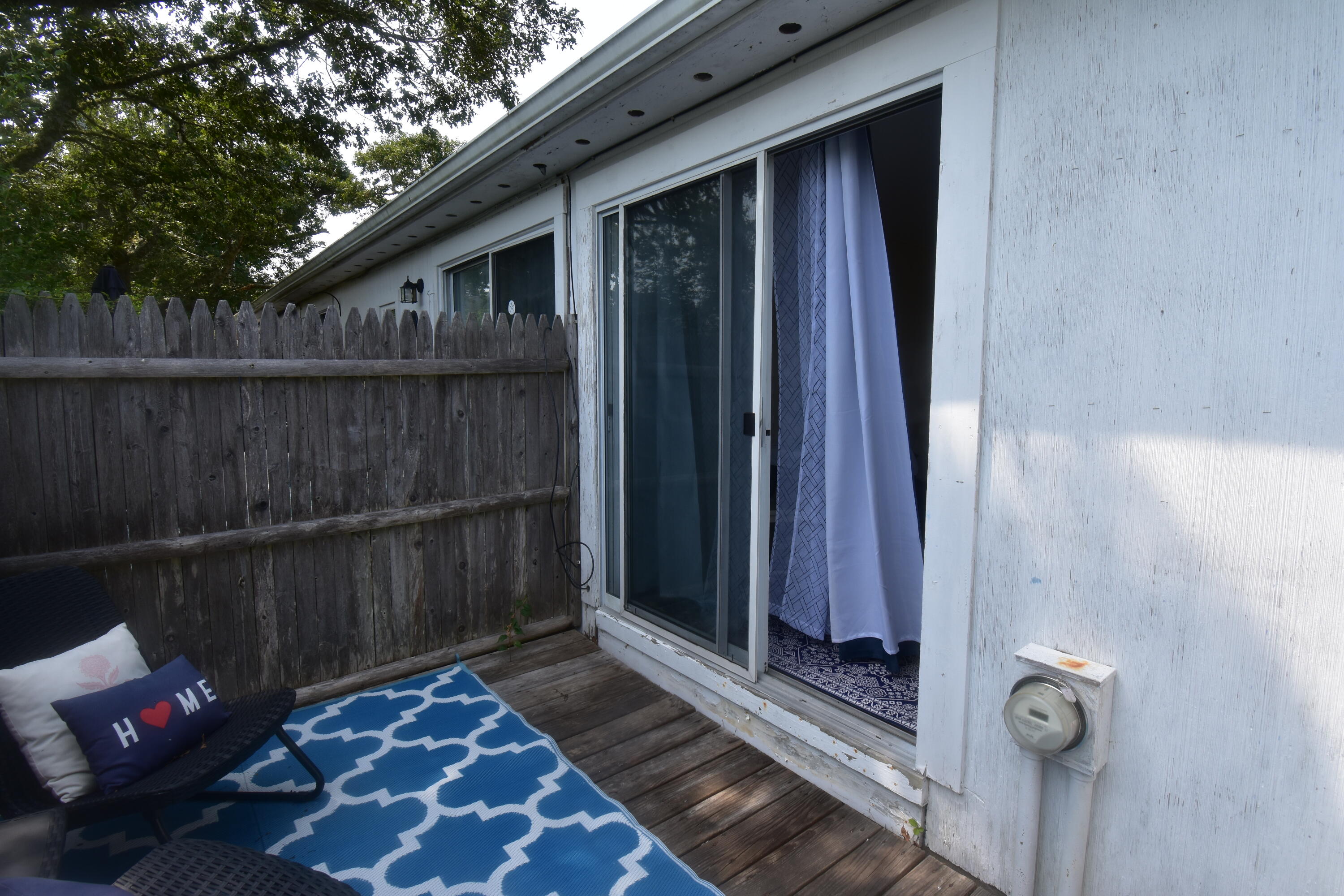 465 Lower County Road, Unit 10B Dennis Port, MA 02639 - Photo 7 of 29 a view of a wooden door and a floor to ceiling window