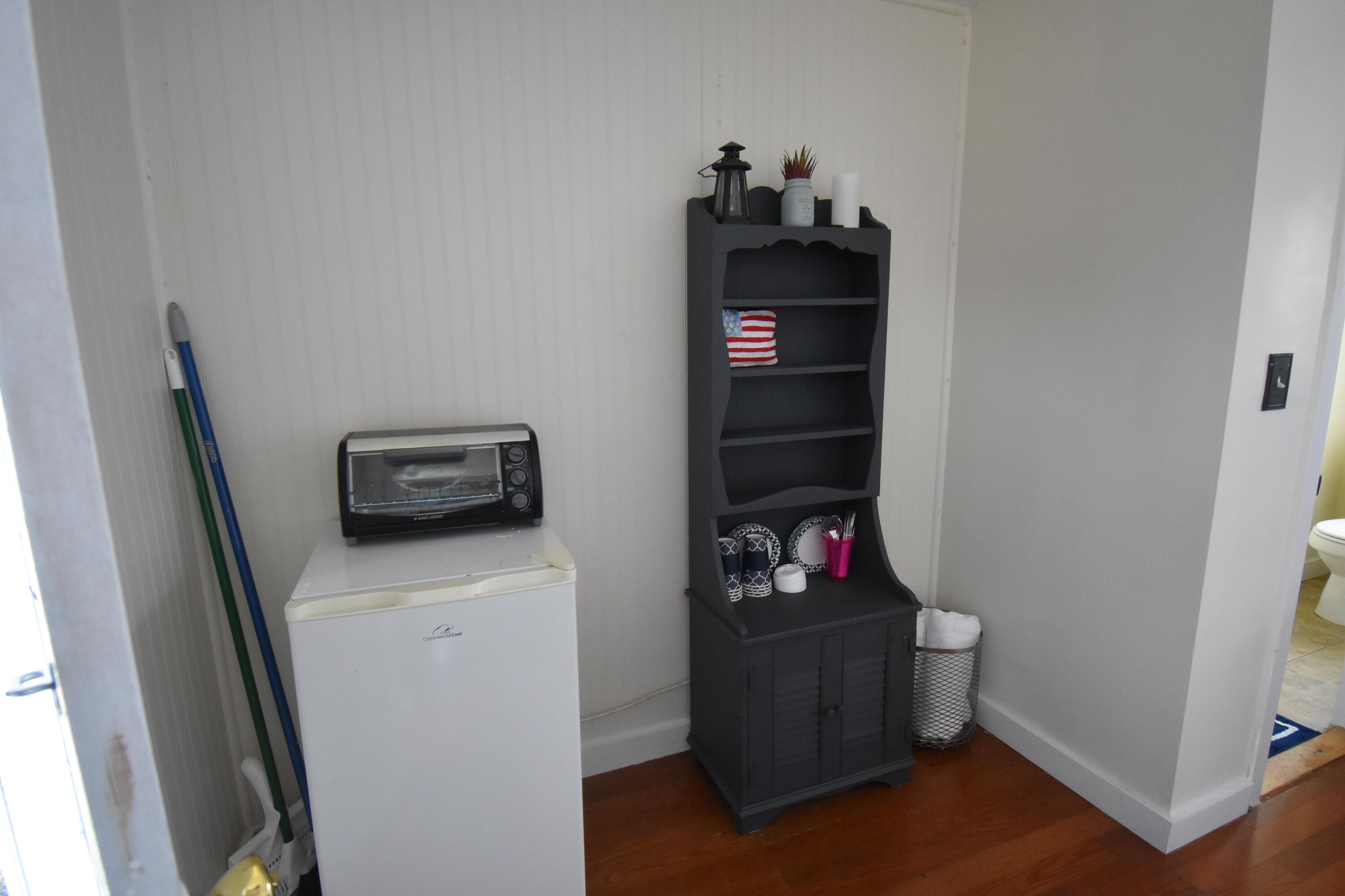 465 Lower County Road, Unit 10B Dennis Port, MA 02639 - Photo 8 of 29 a view of storage and utility room with wooden floor