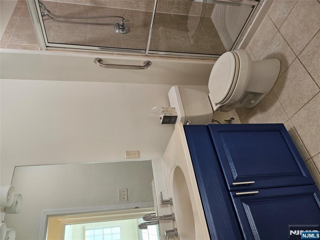 80 Ridgewood Road, Unit 212 Tenafly, NJ 07670 - Photo 11 of 14 a bathroom with a sink toilet and shower
