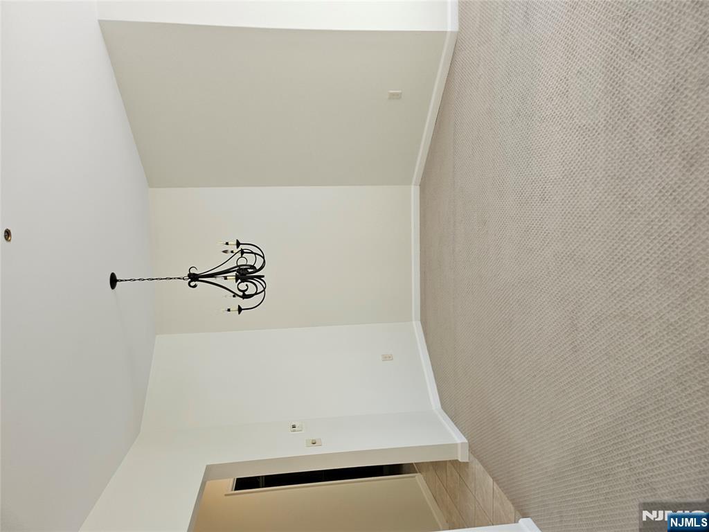 80 Ridgewood Road, Unit 212 Tenafly, NJ 07670 - Photo 6 of 14 a view of a room with a hanging light