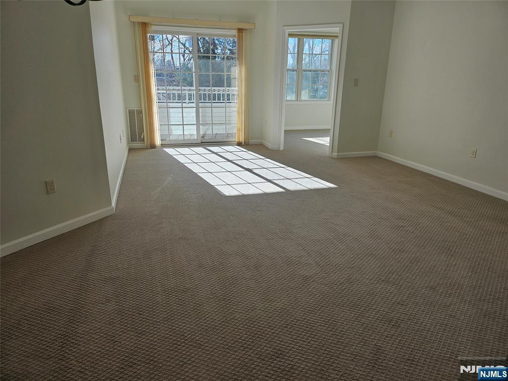 80 Ridgewood Road, Unit 212 Tenafly, NJ 07670 - Photo 7 of 14 an empty room with windows
