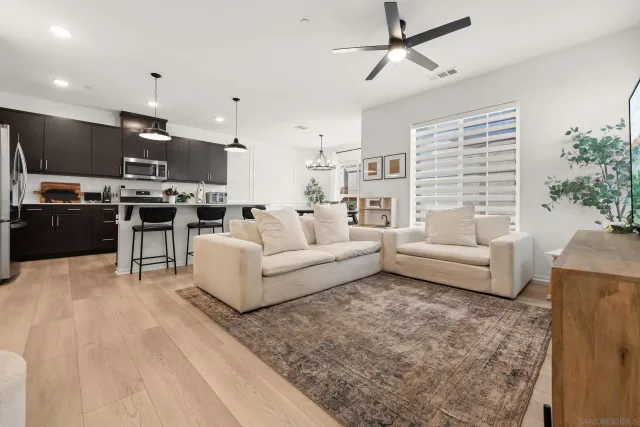 a living room with furniture kitchen and a kitchen island