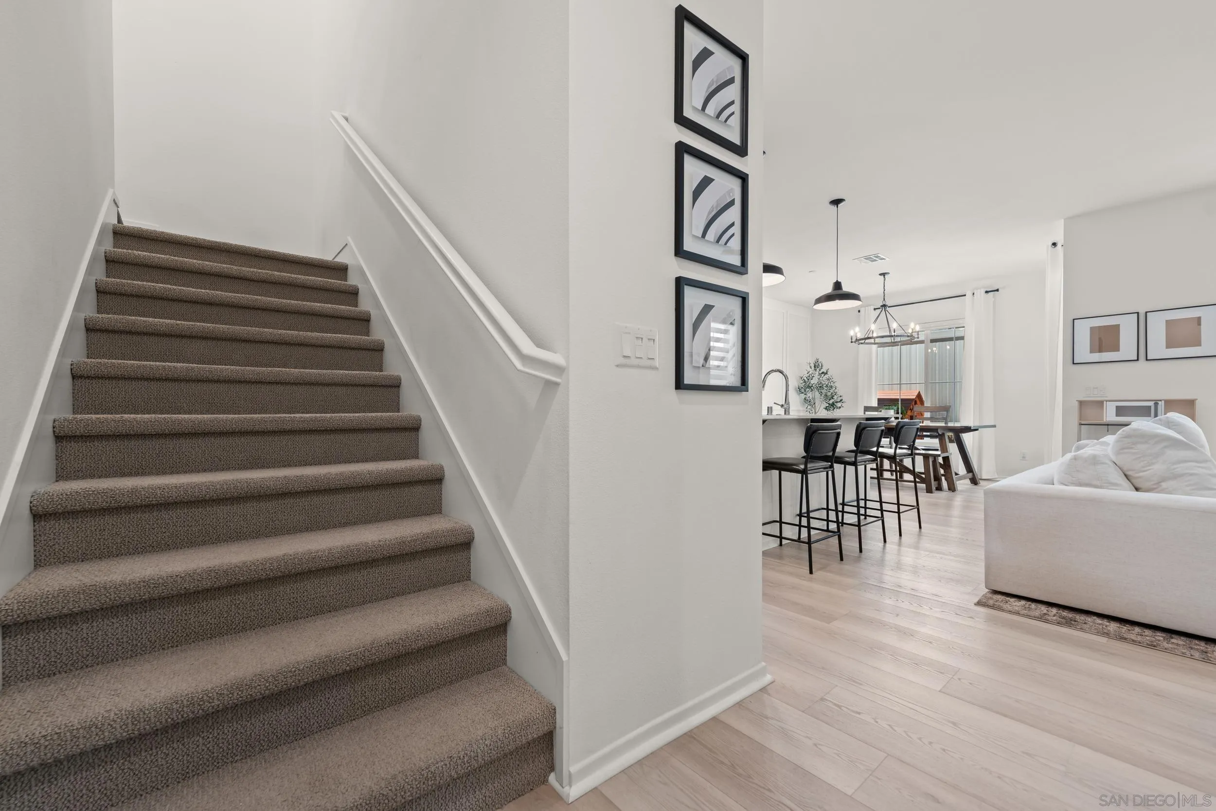 232 Perennial Place Fallbrook, CA 92028 - Photo 17 of 49 a living room with furniture and a dining table with wooden floor