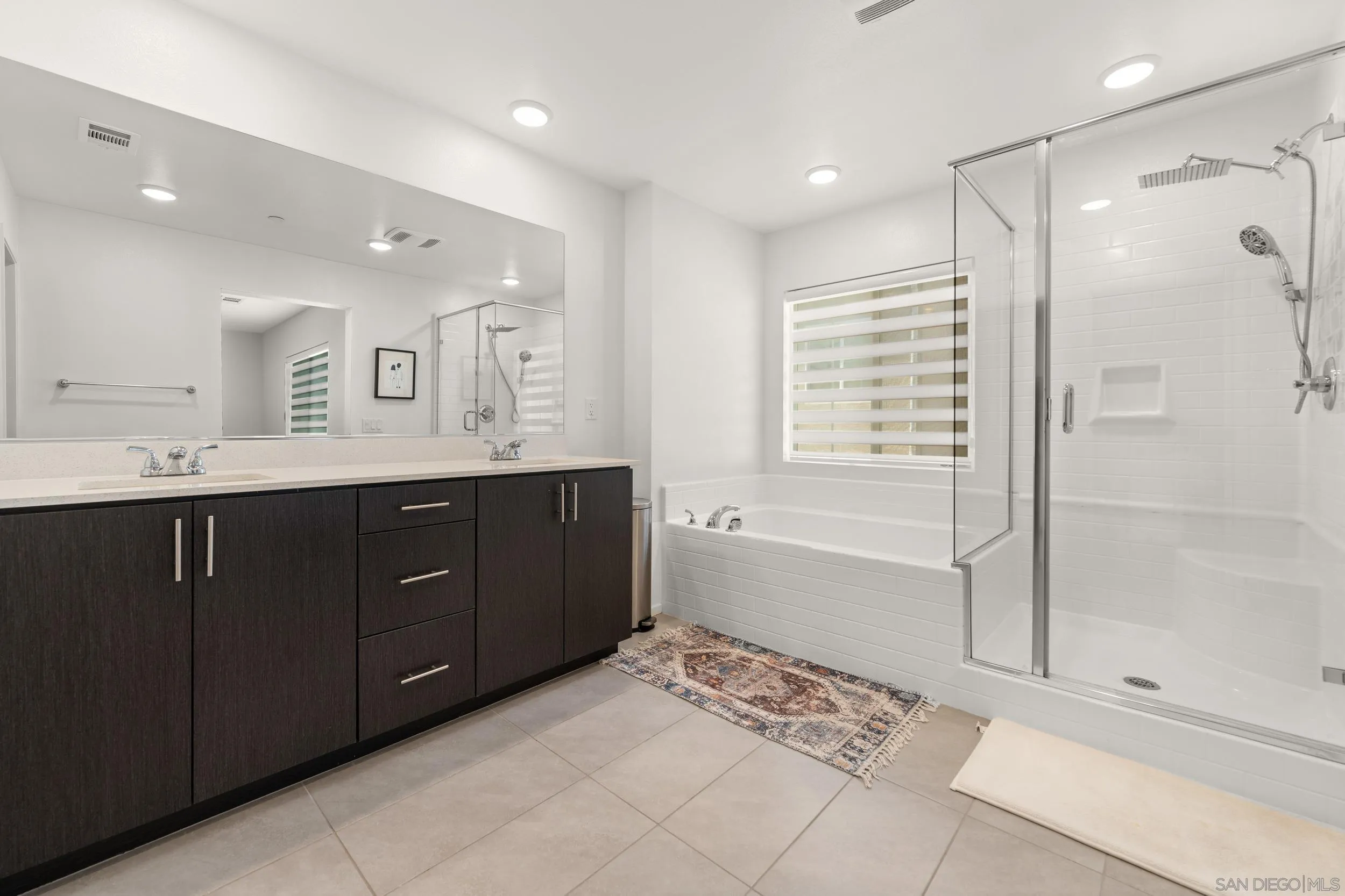 232 Perennial Place Fallbrook, CA 92028 - Photo 22 of 49 a spacious bathroom with a shower sink and mirror