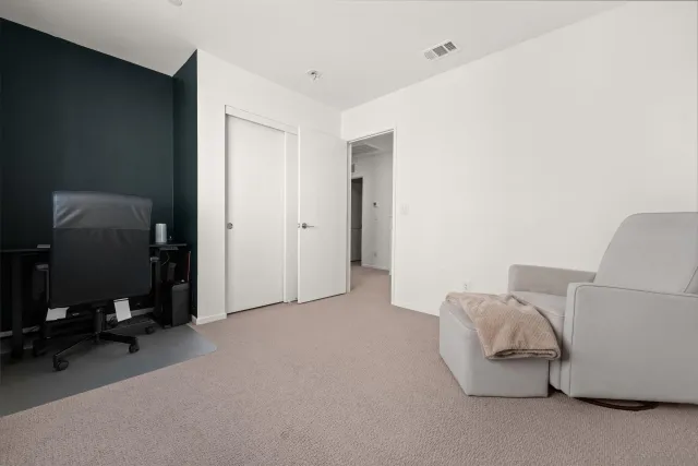 a living room with furniture and a lamp