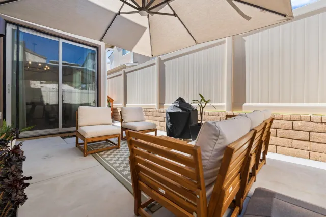 a outdoor space with patio the couches and pool with an umbrella