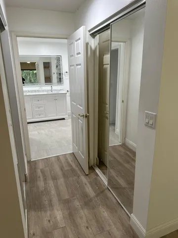an empty room with wooden floor and a bathroom