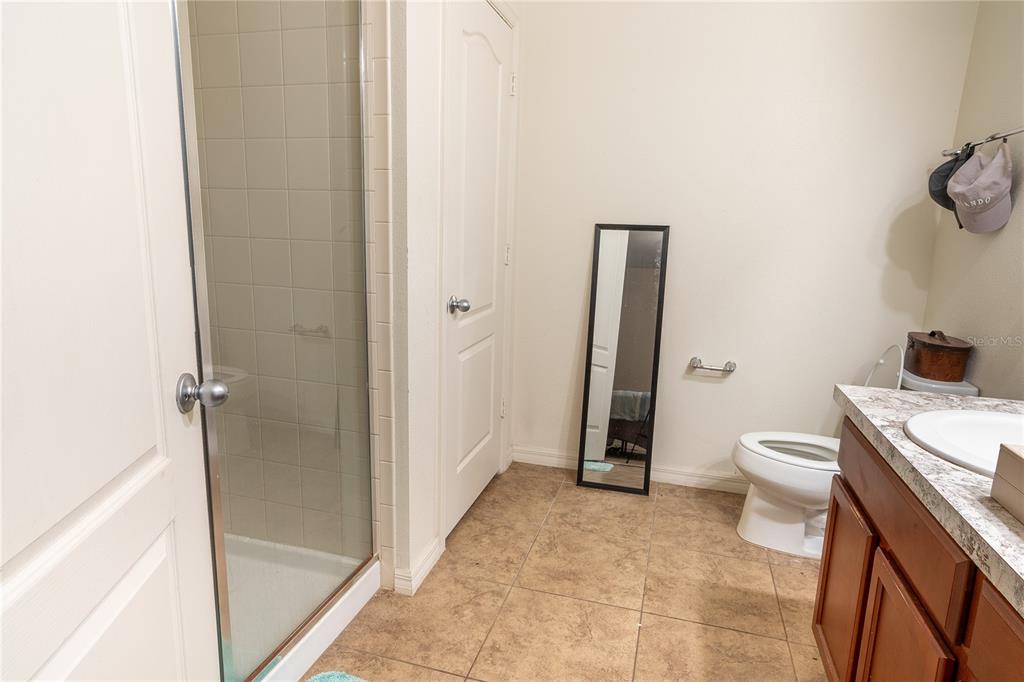 4563 Orchard Grove Road St. Cloud, FL 34772 - Photo 21 of 51 a bathroom with a granite countertop toilet and a sink