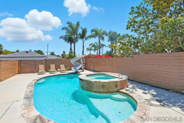 a view of a swimming pool with an outdoor space and seating area