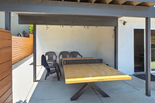 a view of a room with table and chairs