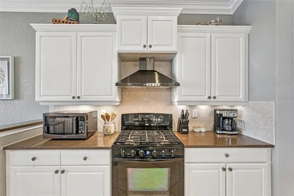 a kitchen with a sink stove and cabinets