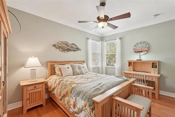 a bedroom with two beds and chandelier