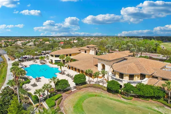 a very nice looking living room with a large mirror and a chandelier