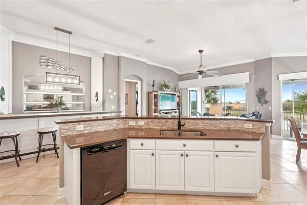 a kitchen with granite countertop white cabinets and stainless steel appliances