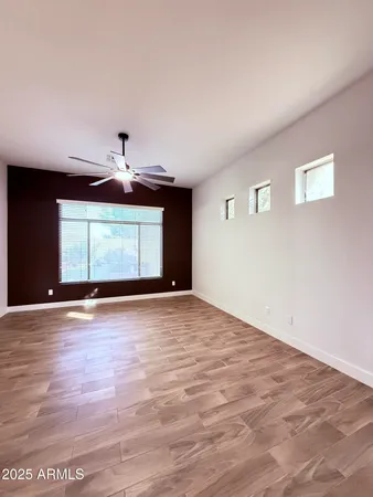 a view of empty room with wooden floor