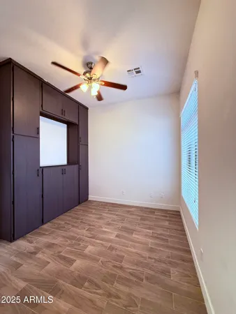 a view of a livingroom with a ceiling fan and window